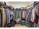 This walk-in closet has ample storage with hanging racks, overhead shelving, and floor storage space at 3079 Limber Pine Dr, Whiteland, IN 46184