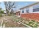 Backyard featuring grass, a brick foundation and partial view of the back of the house at 3125 Anniston Dr, Indianapolis, IN 46227