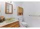 Bathroom featuring a marble sink, wooden storage cabinet, toilet, and towel rack at 3125 Anniston Dr, Indianapolis, IN 46227