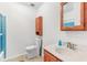 Well-maintained bathroom with a vanity, toilet, and a shower with blue tile at 3125 Anniston Dr, Indianapolis, IN 46227