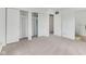 Bright bedroom featuring neutral carpeting, large closets, and a doorway leading to an additional room at 3125 Anniston Dr, Indianapolis, IN 46227