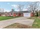 Charming brick home featuring a well-maintained lawn and attached two-car garage at 3125 Anniston Dr, Indianapolis, IN 46227