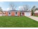 Charming single story brick home with a well-manicured lawn and an attached two car garage at 3125 Anniston Dr, Indianapolis, IN 46227