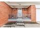 The front porch is framed with classic brickwork, hanging lamps, and minimalist decor at 3125 Anniston Dr, Indianapolis, IN 46227