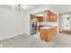 Kitchen with stainless steel refrigerator and breakfast bar, open to living area at 3125 Anniston Dr, Indianapolis, IN 46227