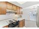 Kitchen showcasing the oven and wooden cabinetry with eat in breakfast bar at 3125 Anniston Dr, Indianapolis, IN 46227