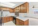 Kitchen featuring wooden cabinetry, stainless steel refrigerator, and breakfast bar at 3125 Anniston Dr, Indianapolis, IN 46227