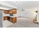 Open floor plan with fireplace and carpet that connects the living room to the kitchen at 3125 Anniston Dr, Indianapolis, IN 46227