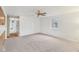 Spacious living room with neutral carpet, white walls, and a ceiling fan, creating an inviting atmosphere at 3125 Anniston Dr, Indianapolis, IN 46227