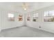 Cozy sunroom with white wood paneling, multiple windows, and ceiling fan for natural light and ventilation at 3125 Anniston Dr, Indianapolis, IN 46227