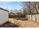 Large backyard with wood pile, detached garage, and wood fence at 317 Albany St, Indianapolis, IN 46225