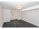 Unfinished basement area with painted floor, overhead light, and closet area at 317 Albany St, Indianapolis, IN 46225