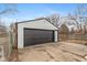 Detached garage with black door and white siding at 317 Albany St, Indianapolis, IN 46225