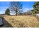 The spacious backyard has well-maintained grass and mature trees at 3226 E 300 N, Anderson, IN 46012