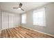Bright bedroom with a ceiling fan, wood-look flooring, and closet with white sliding doors at 3226 E 300 N, Anderson, IN 46012
