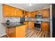 Well-lit kitchen featuring wood cabinets, granite countertops and backsplash, and stainless steel appliances at 3226 E 300 N, Anderson, IN 46012
