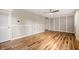 Bright living room with stylish wood floors, decorative wall trim, and a modern ceiling fan at 3226 E 300 N, Anderson, IN 46012