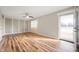 Inviting living room featuring wood flooring, ceiling fan, and natural light from sliding glass door at 3226 E 300 N, Anderson, IN 46012