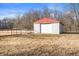 Outbuilding with a roll-up door and white metal siding at 3226 E 300 N, Anderson, IN 46012