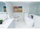 Elegant bathroom featuring marble walls, a modern vanity, and a luxurious soaking tub at 3406 E 20Th St, Indianapolis, IN 46218
