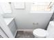 Small updated bathroom features marble vanity and dark tile accent wall at 3406 E 20Th St, Indianapolis, IN 46218