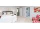 Bright bedroom features a comfortable bed, accent chairs, and an ensuite bathroom at 3406 E 20Th St, Indianapolis, IN 46218