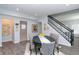 Bright dining area features gray walls, modern furnishings, and a staircase with black railings at 3406 E 20Th St, Indianapolis, IN 46218