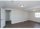 Open-concept living room with wood flooring, neutral walls, and doorway to another room at 3406 E 20Th St, Indianapolis, IN 46218