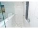 Modern shower with glass doors, marble walls, and mosaic tile accents with chrome fixtures at 3406 E 20Th St, Indianapolis, IN 46218