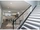Staircase between first and second floor with black and white painted wood at 3406 E 20Th St, Indianapolis, IN 46218