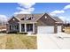 Charming brick home featuring a well-manicured lawn, dormers, and a spacious two-car garage at 3532 Danbury Ct, Bargersville, IN 46106