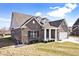 Beautiful brick home with dormers, manicured lawn, and covered porch with white columns at 3532 Danbury Ct, Bargersville, IN 46106