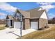 Side view of a brick home with a driveway and a basketball hoop above the two car garage at 3532 Danbury Ct, Bargersville, IN 46106