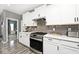 A modern kitchen features white cabinets, grey subway tile backsplash, and stainless steel appliances at 3532 Danbury Ct, Bargersville, IN 46106