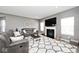 Cozy living room with a fireplace, plush sofas, and ample natural light with gray color palette at 3532 Danbury Ct, Bargersville, IN 46106