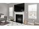Comfortable living room featuring a fireplace, large TV, and stylish decor and luxury vinyl flooring at 3532 Danbury Ct, Bargersville, IN 46106