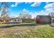 Backyard features green lawn, a trampoline and a barn at 358 Webb Dr, Indianapolis, IN 46227