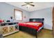Cozy bedroom with ceiling fan, window, dark furniture and grey walls at 358 Webb Dr, Indianapolis, IN 46227