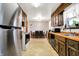 Open dining room and kitchen area with stainless steel appliances and warm wood cabinets at 358 Webb Dr, Indianapolis, IN 46227