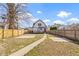 Exterior view of backyard featuring a grass and a cement area and wooden fence at 360 S Spencer Ave, Indianapolis, IN 46219