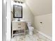 Bathroom featuring a vanity with drawers, a toilet, and decorative marble-look flooring at 360 S Spencer Ave, Indianapolis, IN 46219