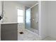 Modern bathroom featuring a marble tiled floor, glass shower and gray vanity at 360 S Spencer Ave, Indianapolis, IN 46219