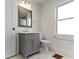 Bathroom featuring a gray vanity cabinet, marble tiled floor, and vintage-style accessories at 360 S Spencer Ave, Indianapolis, IN 46219