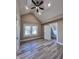 Bedroom with vinyl plank flooring featuring large window, ceiling fan and ensuite access at 360 S Spencer Ave, Indianapolis, IN 46219