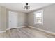 Bedroom boasts a modern ceiling fan, large window, and neutral walls at 360 S Spencer Ave, Indianapolis, IN 46219