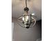Stylish light fixture with wood and metal accents, offering a touch of rustic elegance to the home's interior at 360 S Spencer Ave, Indianapolis, IN 46219