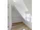 Walk-in closet with slanted ceilings, shelving, window, and hardwood-look flooring at 360 S Spencer Ave, Indianapolis, IN 46219