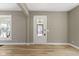 Neutral entryway features attractive wood floors, inviting natural light and access to the sunroom at 360 S Spencer Ave, Indianapolis, IN 46219