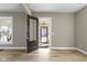 Bright entryway showcases wood floors and an open doorway to the cozy sunroom at 360 S Spencer Ave, Indianapolis, IN 46219