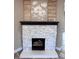 Charming fireplace with decorative accents, complemented by hardwood floors and a clean, modern aesthetic at 360 S Spencer Ave, Indianapolis, IN 46219